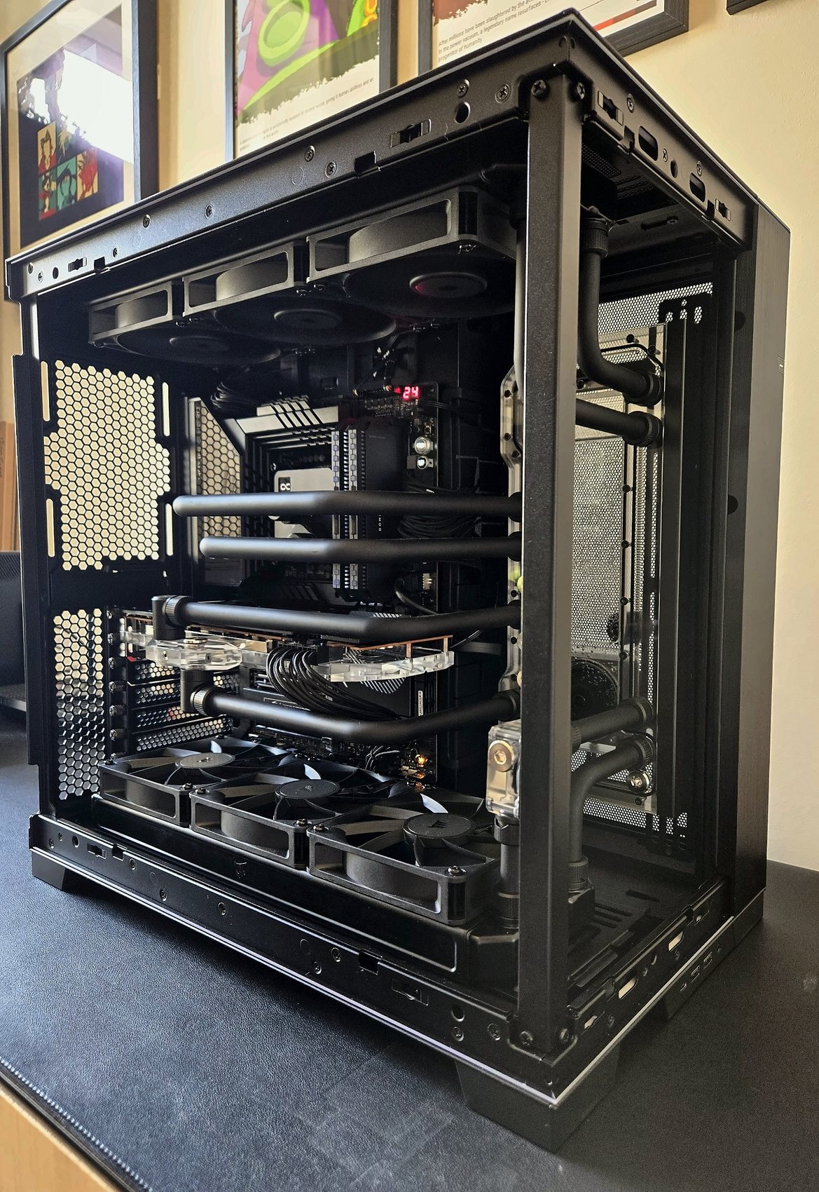 Matte black custom PC build with distro plate, angled view