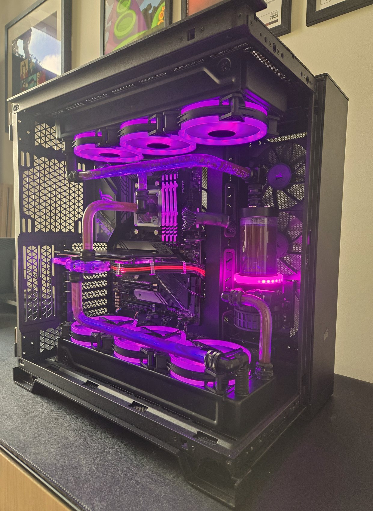 Custom water-cooled gaming PC with purple coolant and lighting